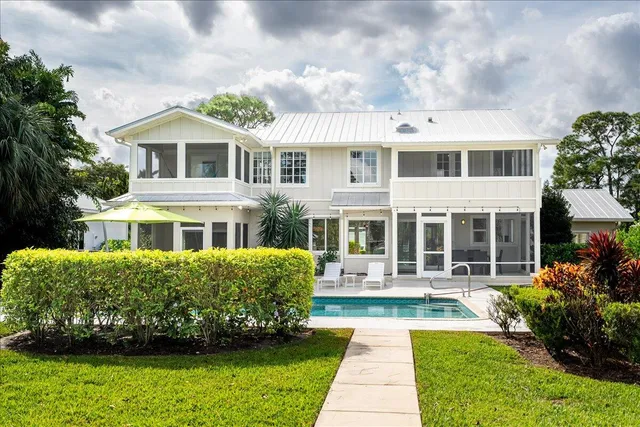 an aerial view of residential houses with outdoor space and swimming pool