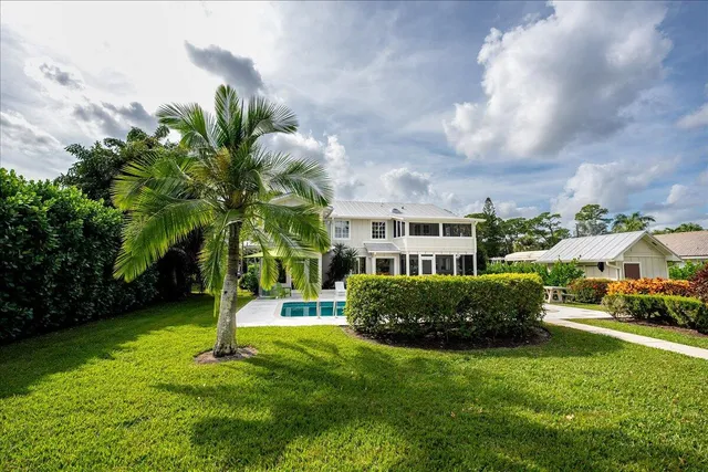 an aerial view of a house with garden space and lake view