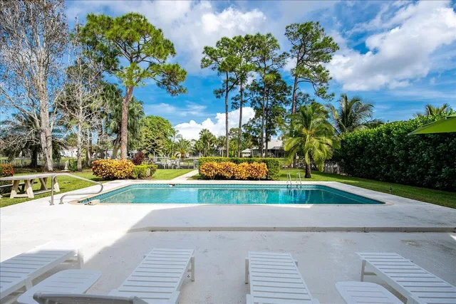 an aerial view of house with yard and swimming pool