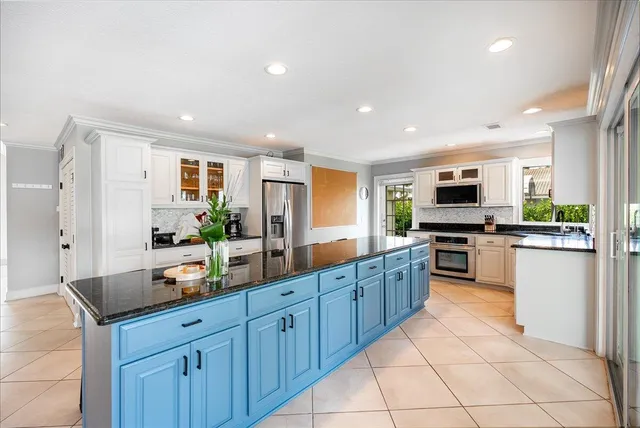 a room with pool table and two mirrors