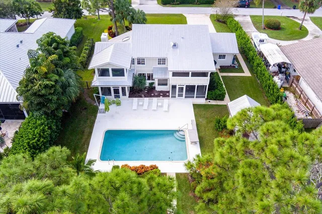 an aerial view of a house with outdoor space and pool