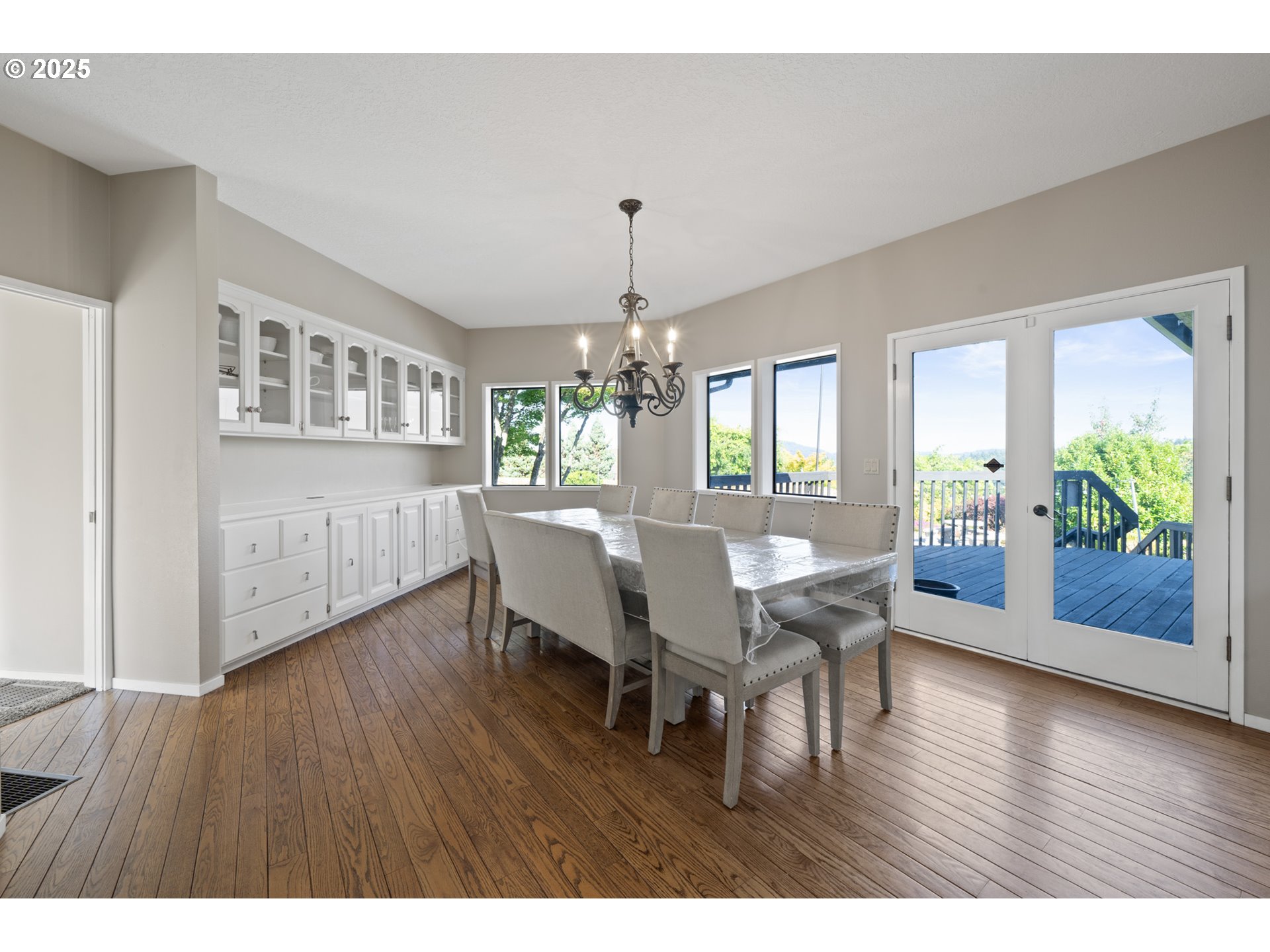 14330 Southeast Donatello Loop Happy Valley, OR 97086 - Photo 11 of 45 a view of a dining room with furniture window and wooden floor