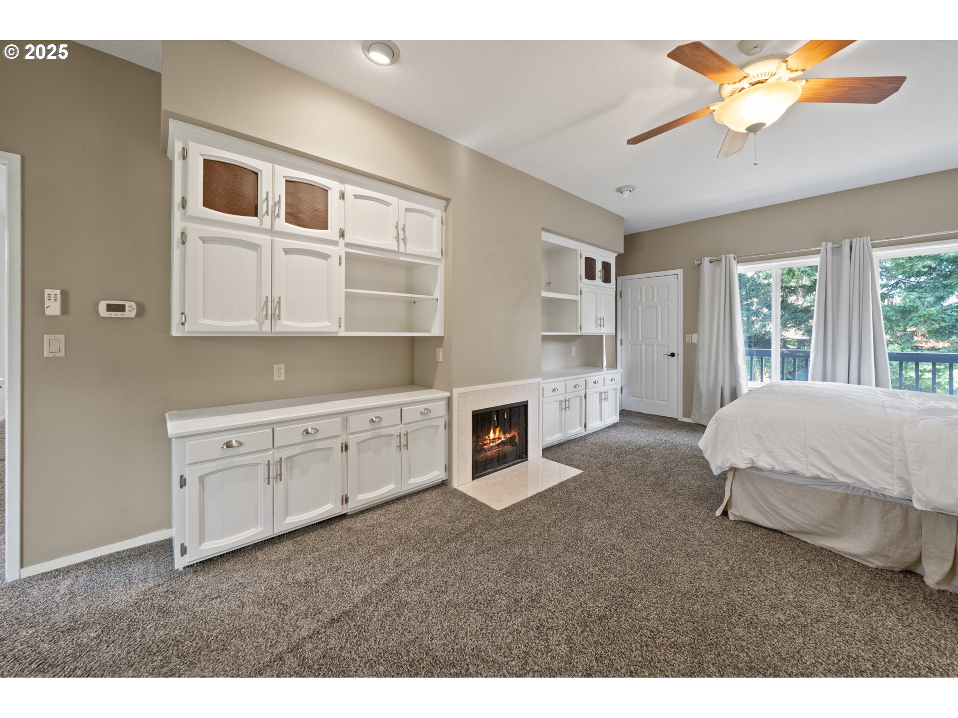 14330 Southeast Donatello Loop Happy Valley, OR 97086 - Photo 15 of 45 a spacious bedroom with a bed and a chandelier