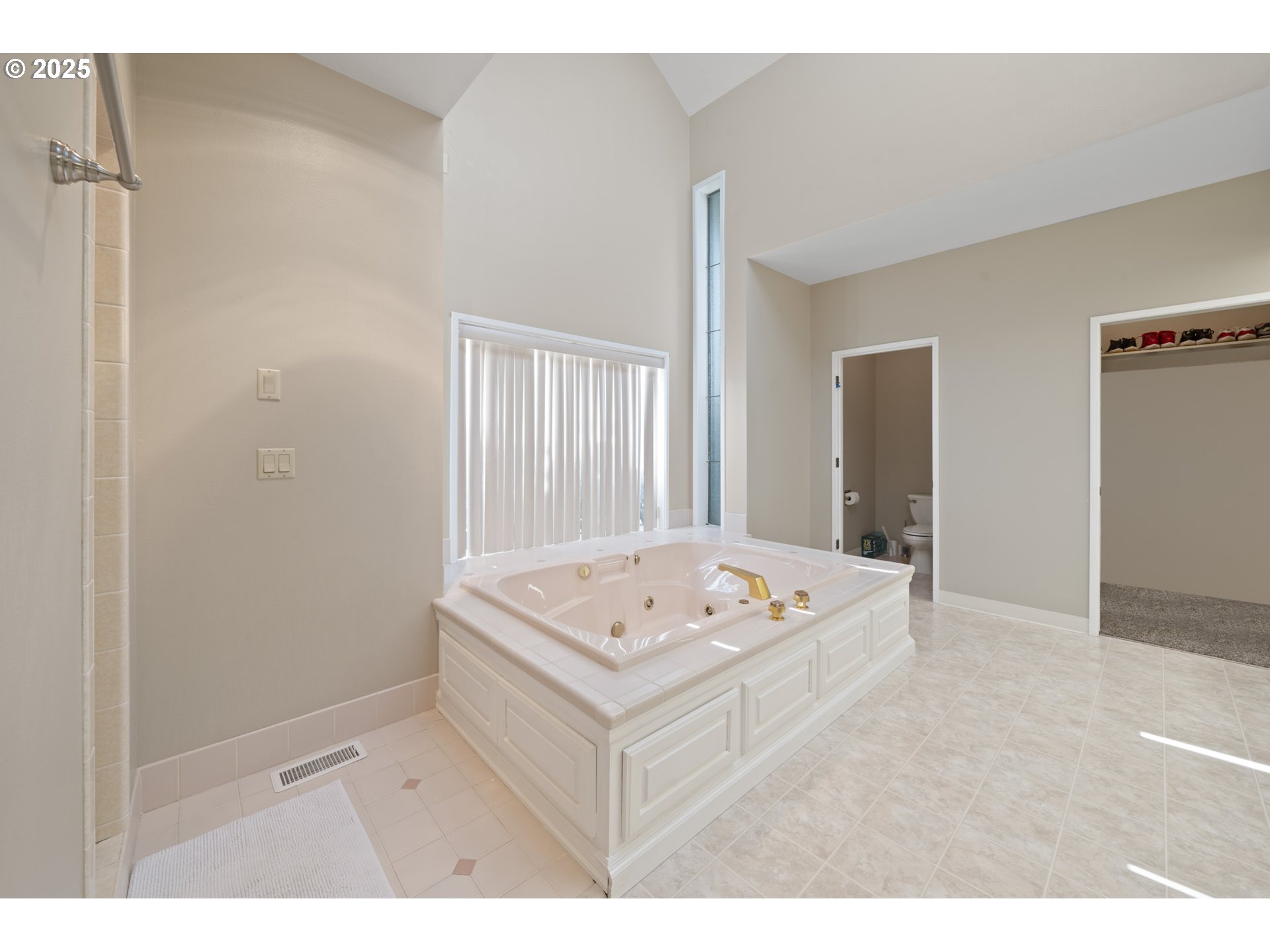 14330 Southeast Donatello Loop Happy Valley, OR 97086 - Photo 17 of 45 a white bath tub sitting in a bathroom