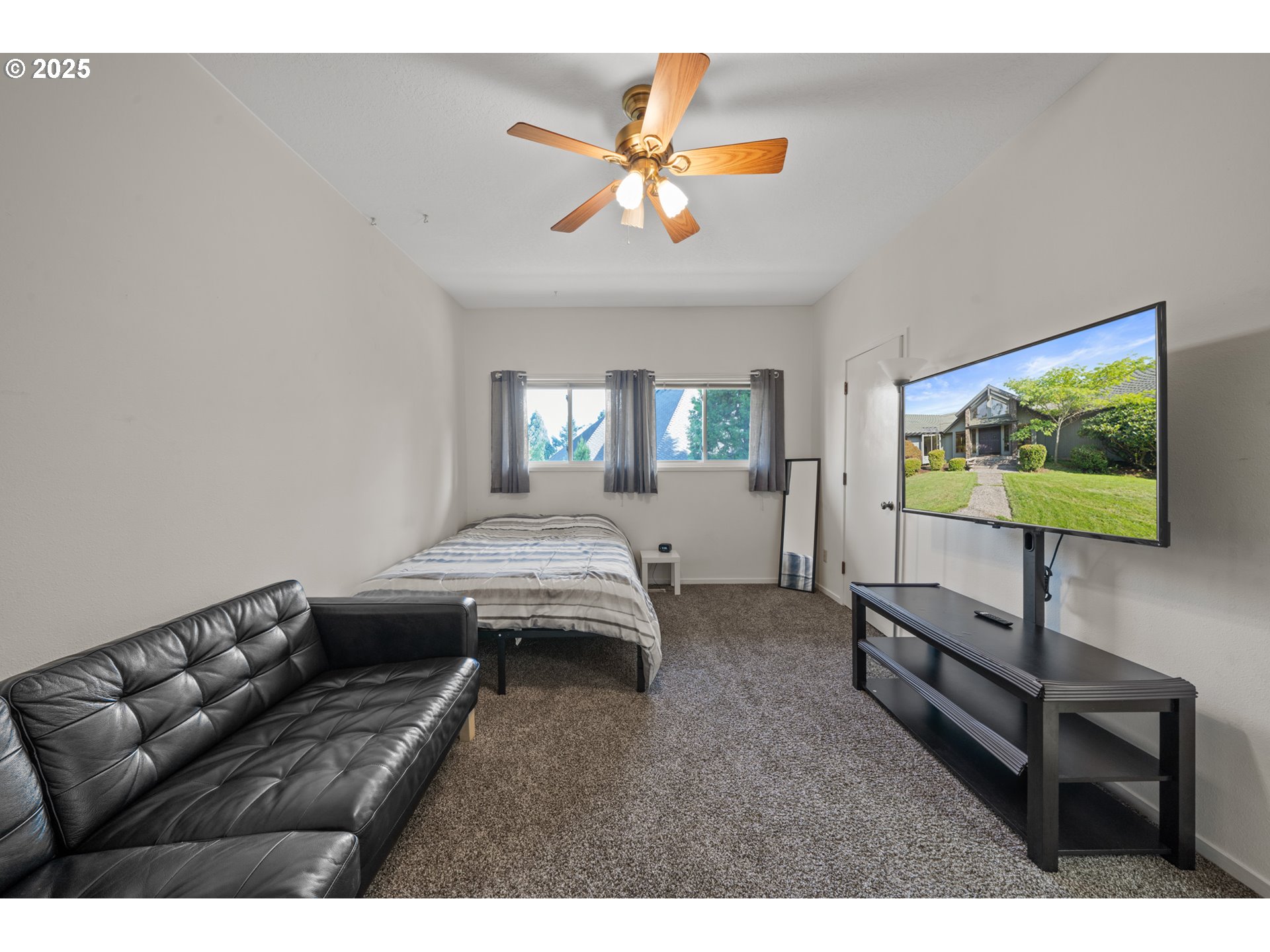 14330 Southeast Donatello Loop Happy Valley, OR 97086 - Photo 21 of 45 a living room with furniture and a flat screen tv