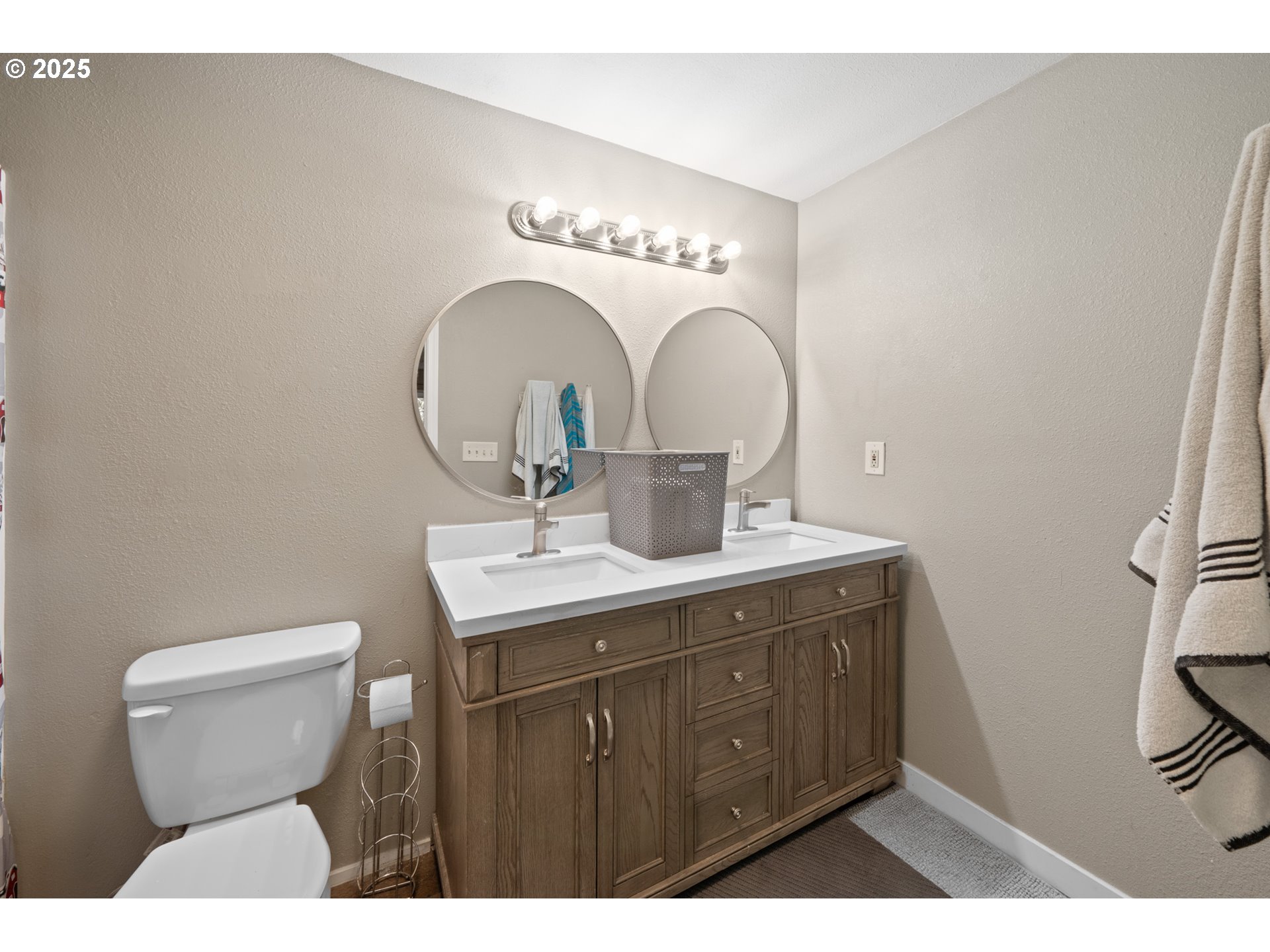 14330 Southeast Donatello Loop Happy Valley, OR 97086 - Photo 32 of 45 a bathroom with a toilet sink and mirror