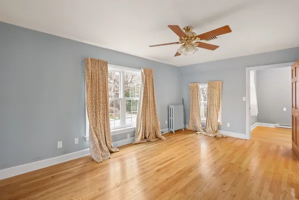 a view of an empty room with wooden floor