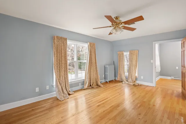 a view of an empty room with wooden floor