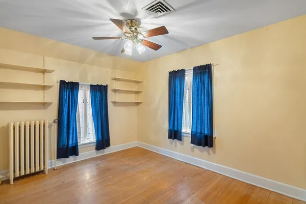 a view of a porch with wooden floor and floor to ceiling window