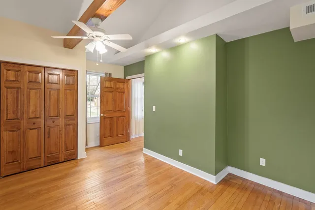 a view of an empty room with window and fire place