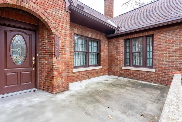 a view of a brick house with a large windows