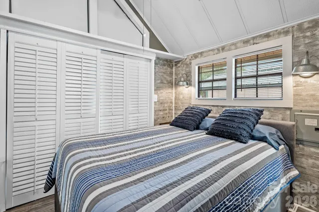 a bedroom with a large bed and a large window