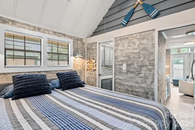 a bedroom with double bed and a large window