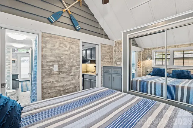 a bedroom with furniture and large windows