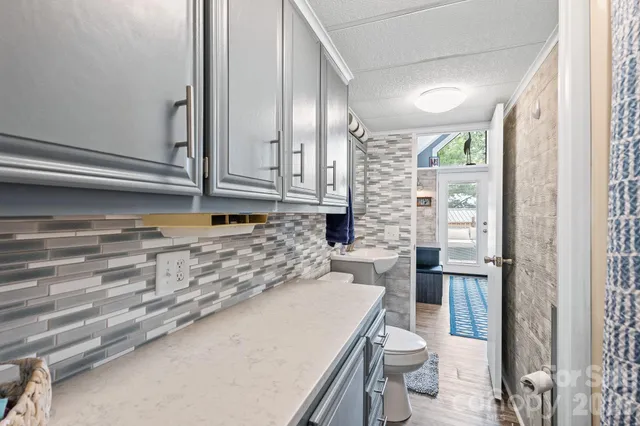 a bathroom with a sink a toilet and shower