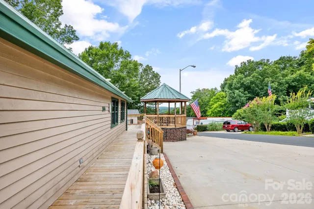 a view of a house with a yard and wooden fence