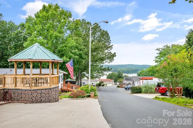 an aerial view of a house with a yard and lake view