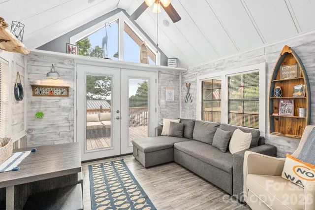 a living room with furniture a rug and a window