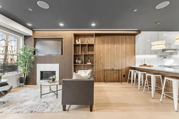a living room with furniture a fireplace and a table