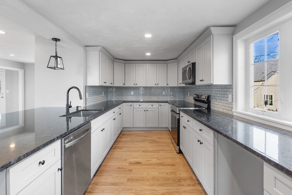 108 High Street Wareham, MA 02571 - Photo 14 of 40 a large kitchen with stainless steel appliances granite countertop a sink and cabinets