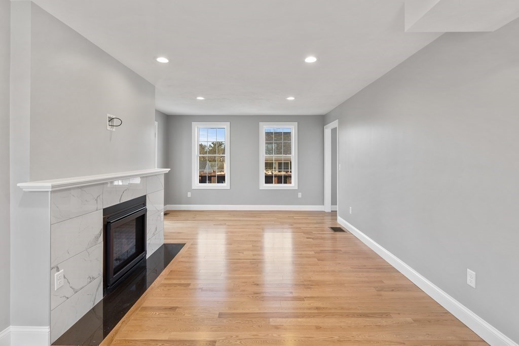 108 High Street Wareham, MA 02571 - Photo 16 of 40 a view of an empty room with a fireplace and a window