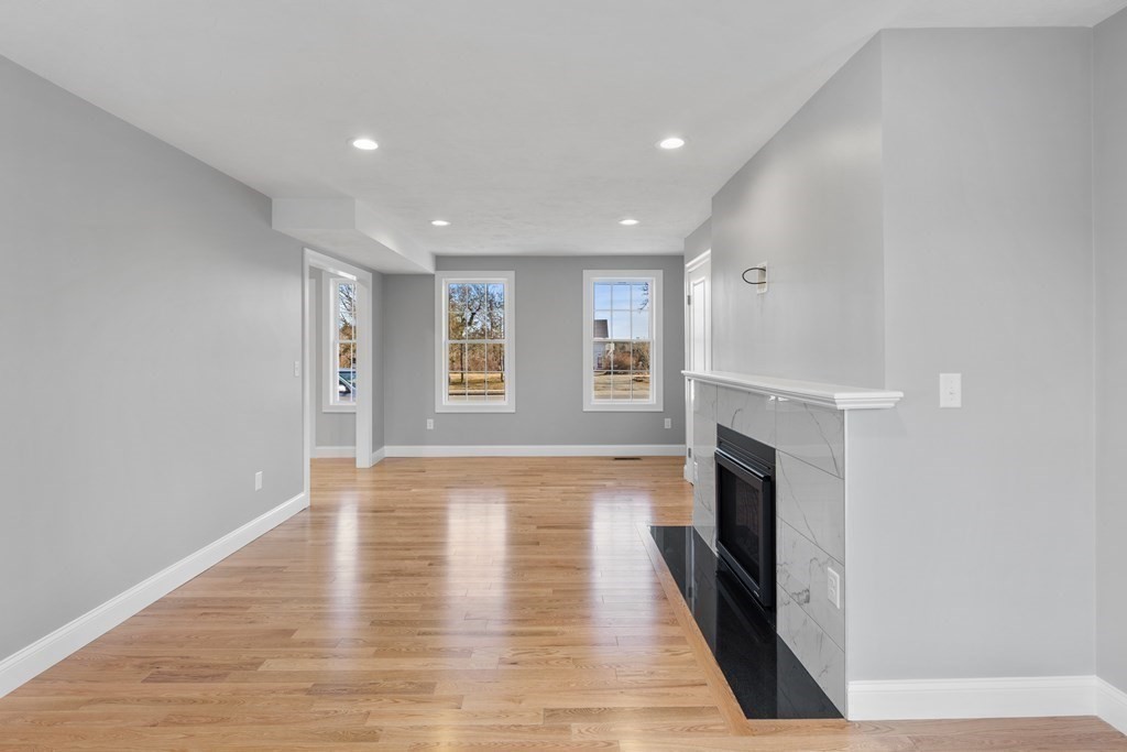 108 High Street Wareham, MA 02571 - Photo 17 of 40 a view of empty room with wooden floor and fireplace