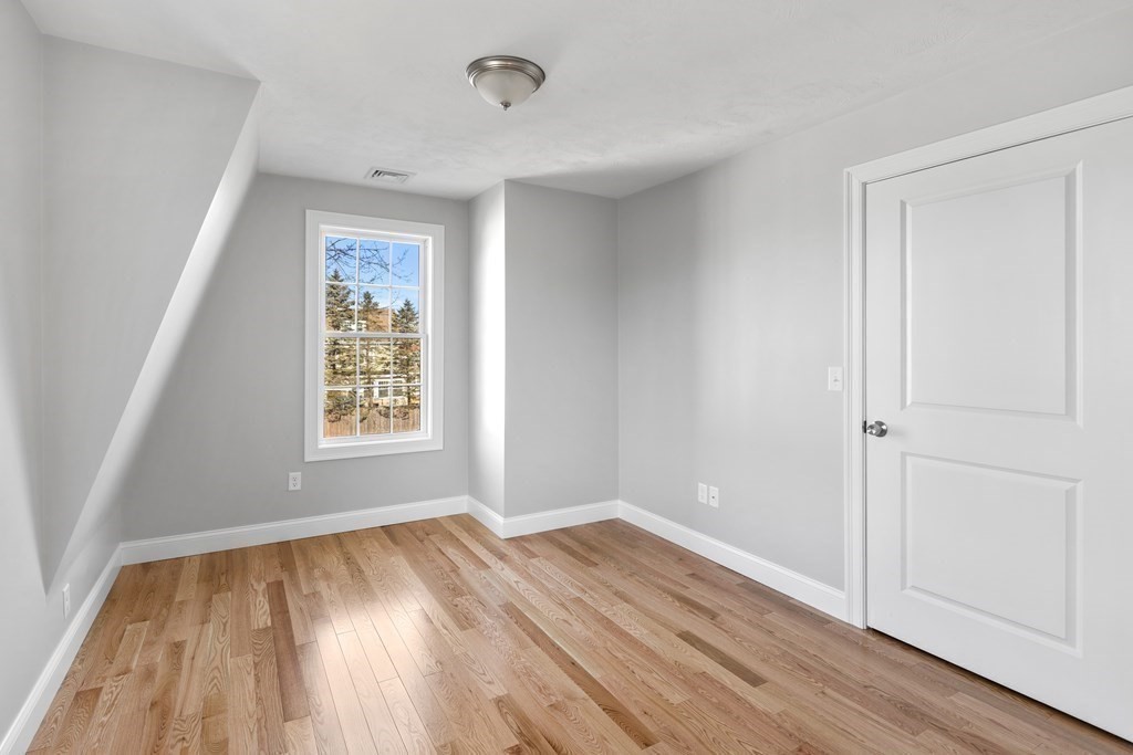 108 High Street Wareham, MA 02571 - Photo 21 of 40 an empty room with wooden floor and windows