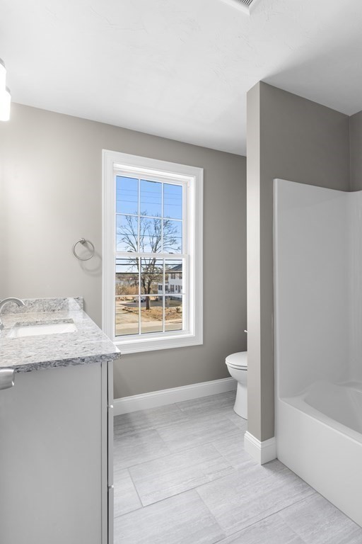 108 High Street Wareham, MA 02571 - Photo 27 of 40 a bathroom with a granite countertop toilet a sink and bathtub