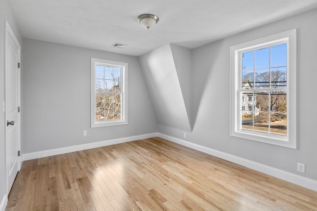 108 High Street Wareham, MA 02571 - Photo 29 of 40 a view of an empty room with wooden floor and a window