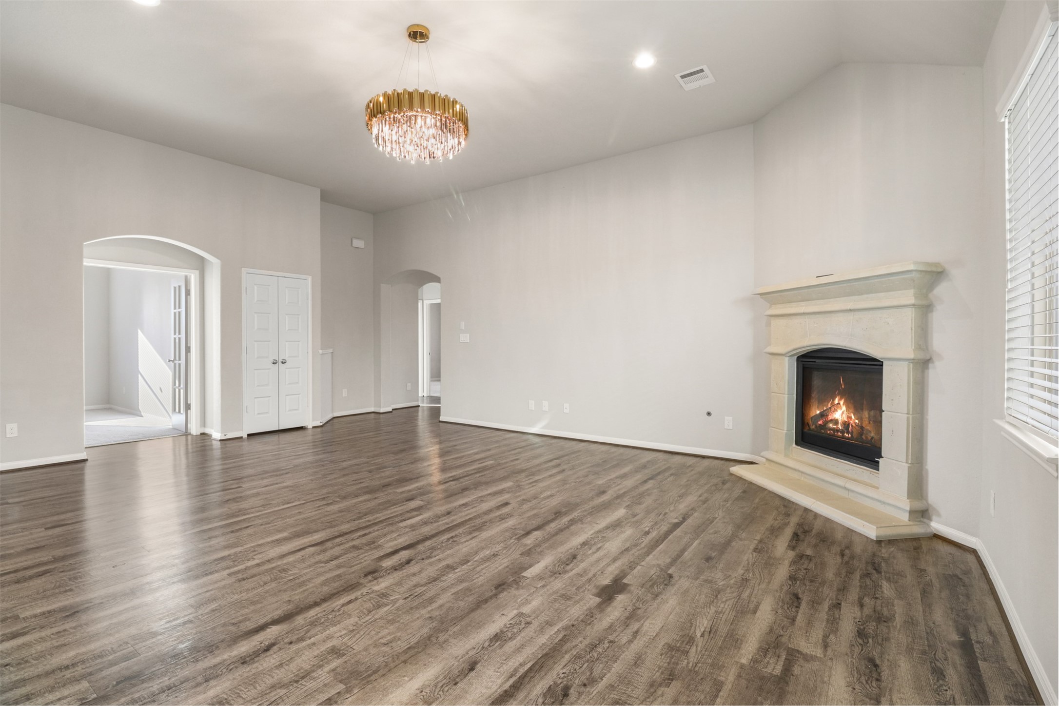 6010 Mapleton Meadow Lane Richmond, TX 77407 - Photo 11 of 34 a view of an empty room with wooden floor and a fireplace