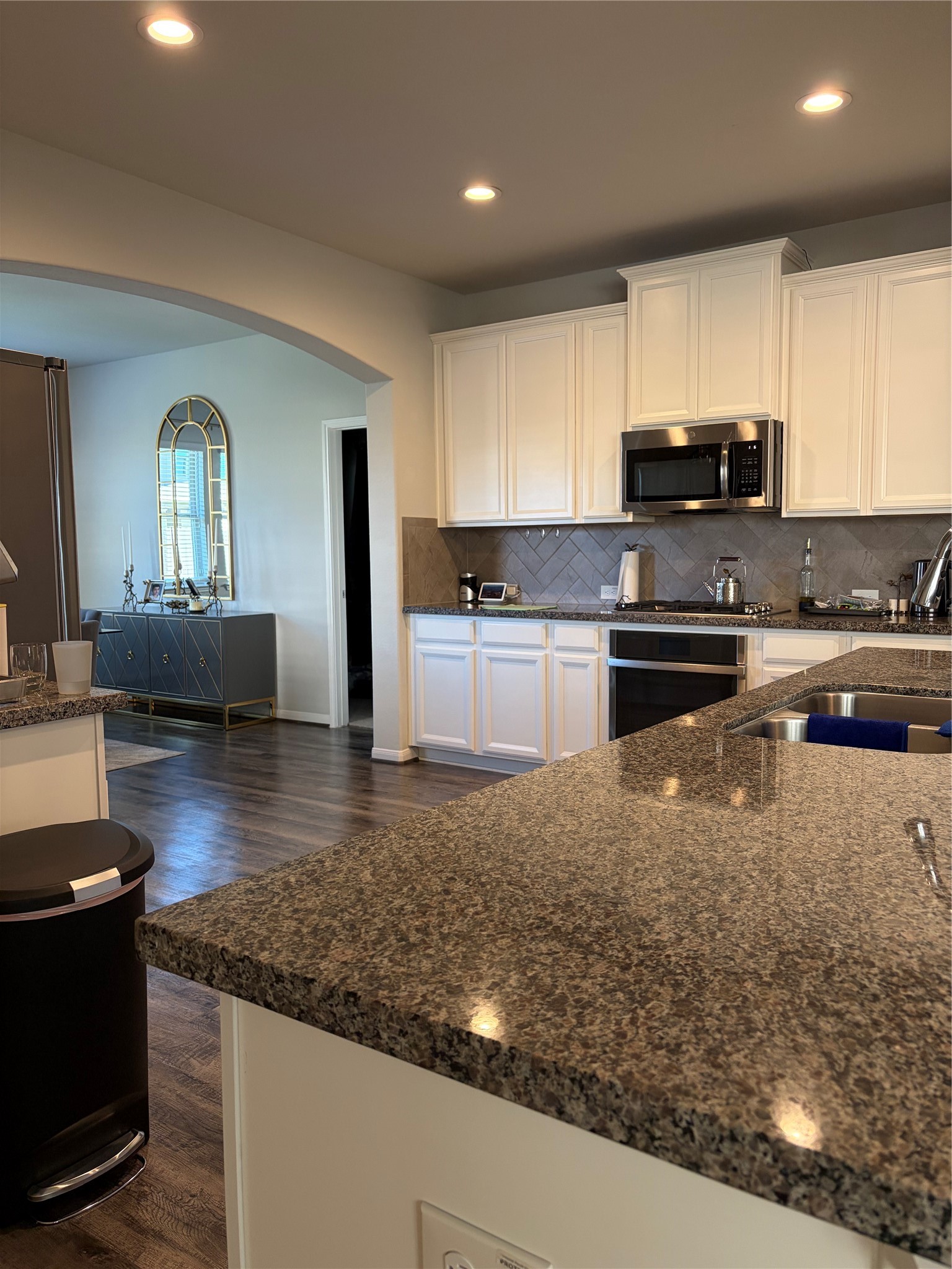 6010 Mapleton Meadow Lane Richmond, TX 77407 - Photo 29 of 34 a kitchen with stainless steel appliances granite countertop a sink stove and cabinets