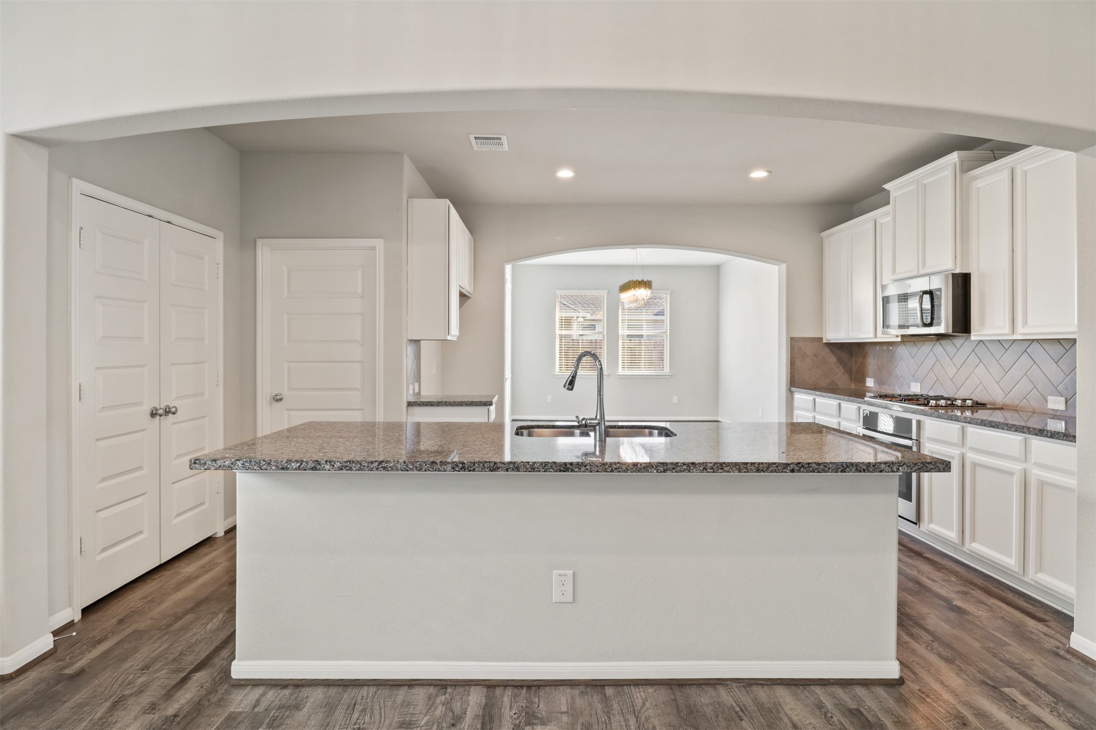6010 Mapleton Meadow Lane Richmond, TX 77407 - Photo 7 of 34 a kitchen with stainless steel appliances granite countertop a white cabinets a sink and dishwasher