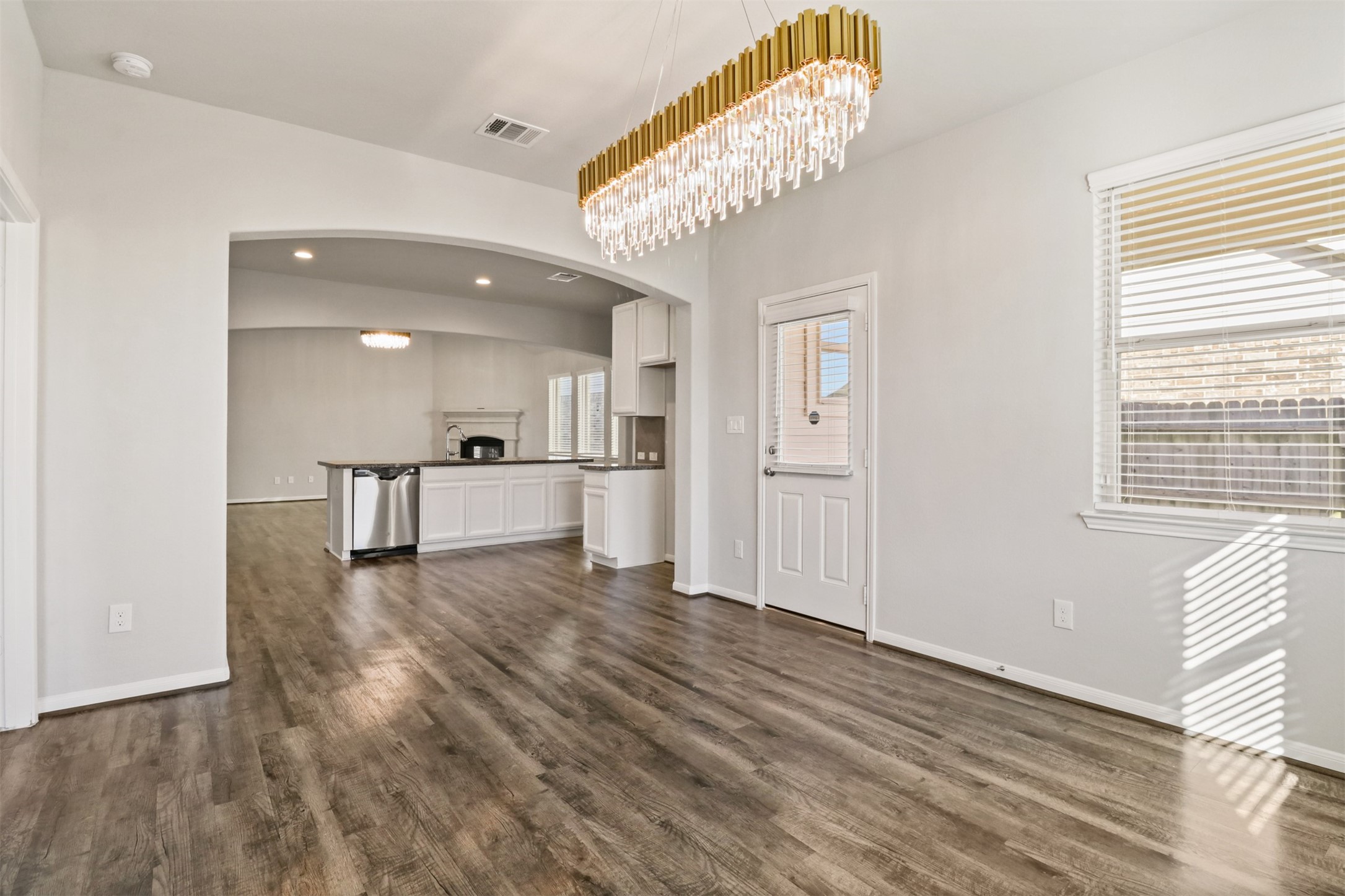 6010 Mapleton Meadow Lane Richmond, TX 77407 - Photo 9 of 34 a view of an empty room with wooden floor and a window