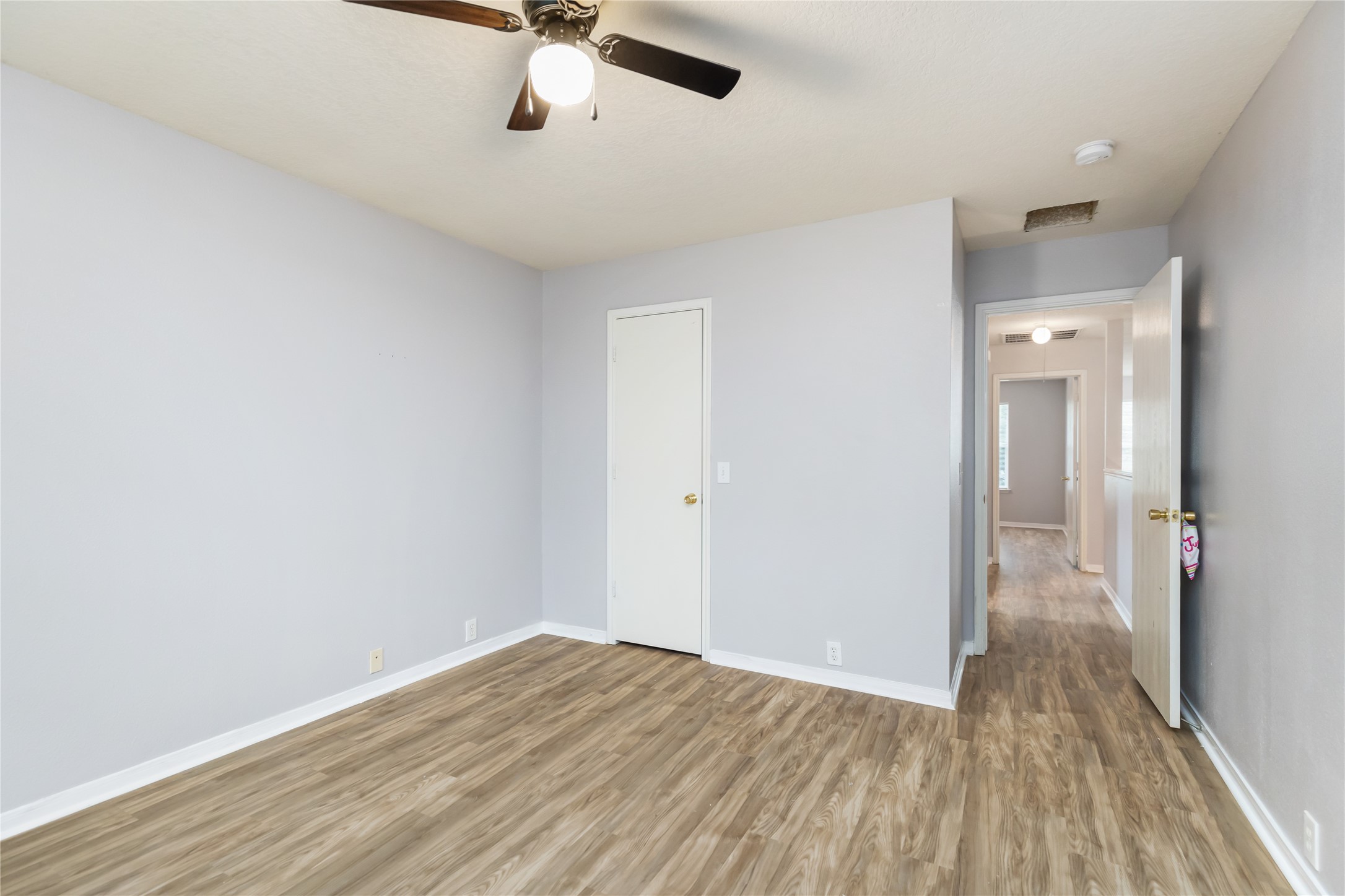 17334 Turquoise Stream Drive Houston, TX 77095 - Photo 11 of 31 wooden floor in an empty room with a window
