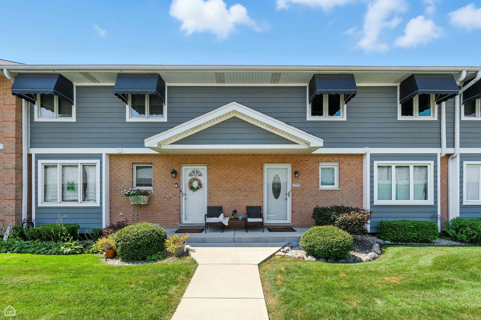 2550 West 112th Street, Unit 12L Chicago, IL 60655 - Photo 1 of 24 a front view of a house with a yard