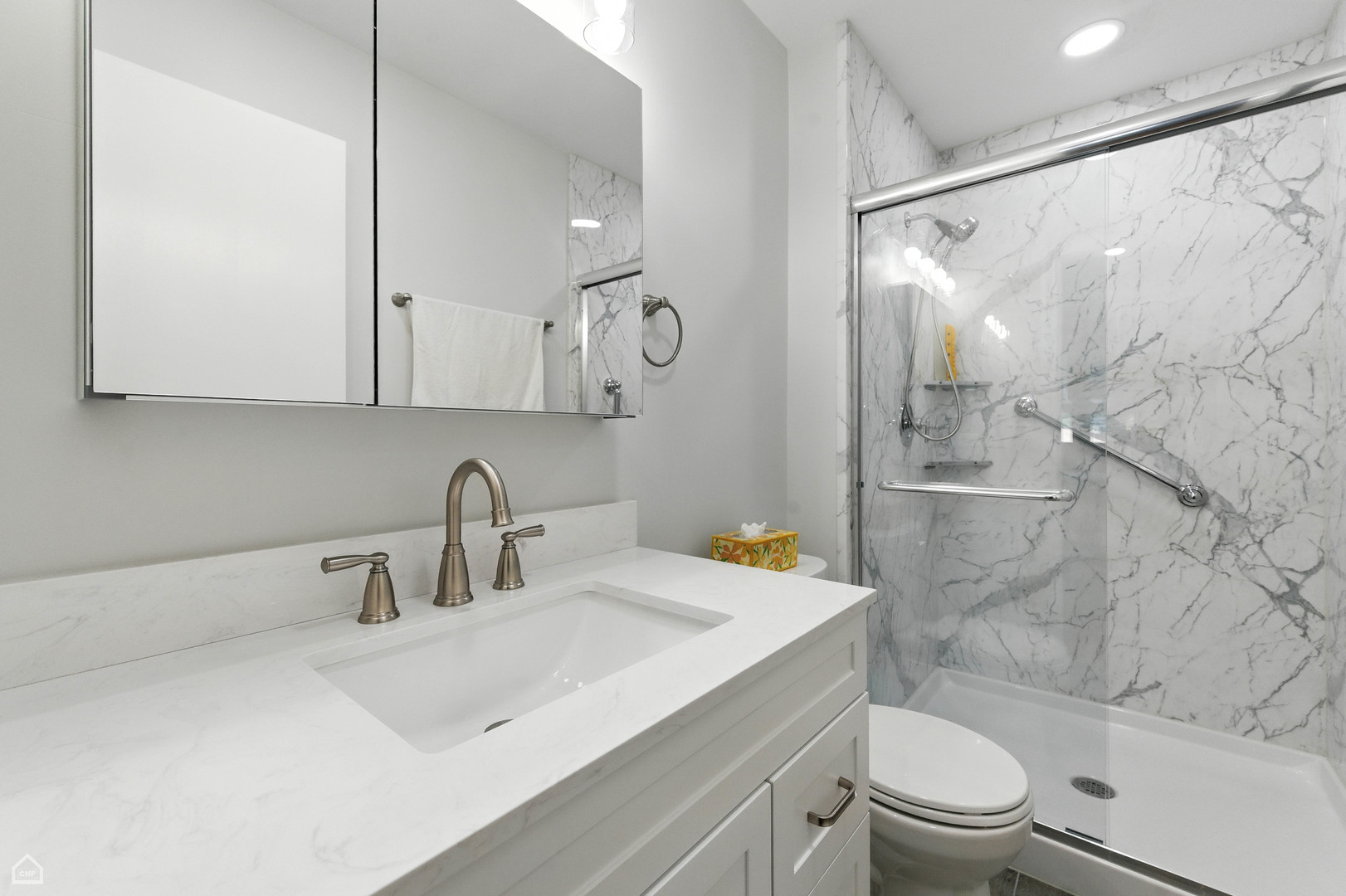 2550 West 112th Street, Unit 12L Chicago, IL 60655 - Photo 11 of 24 a bathroom with a sink a toilet and shower