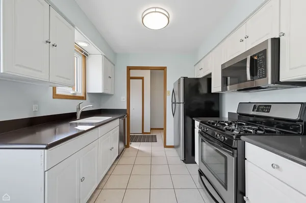 a kitchen with stainless steel appliances granite countertop a stove a sink and a refrigerator