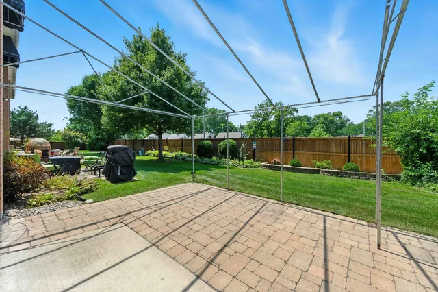 a view of backyard with plants and outdoor seating