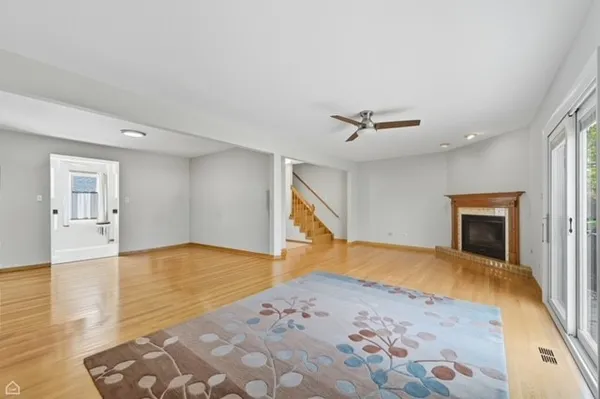 a view of a livingroom with wooden floor and a ceiling fan