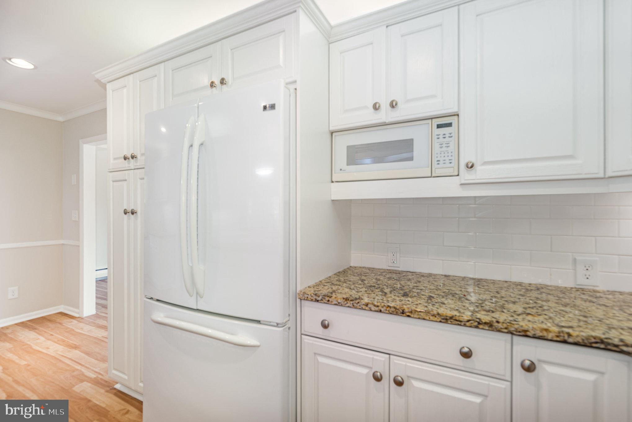 939 Starbit Road Towson, MD 21286 - Photo 13 of 52 a bathroom with white cabinets and a sink