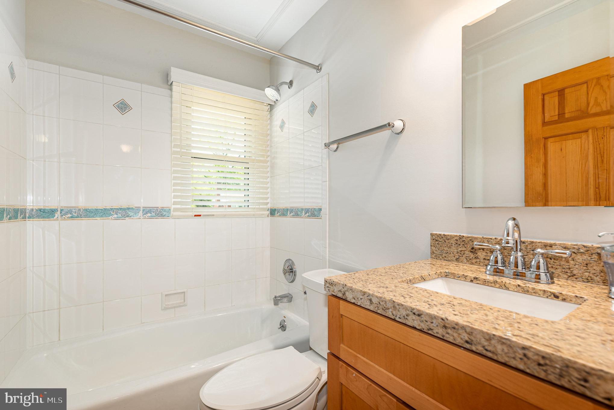 939 Starbit Road Towson, MD 21286 - Photo 15 of 52 a bathroom with a granite countertop sink toilet and shower