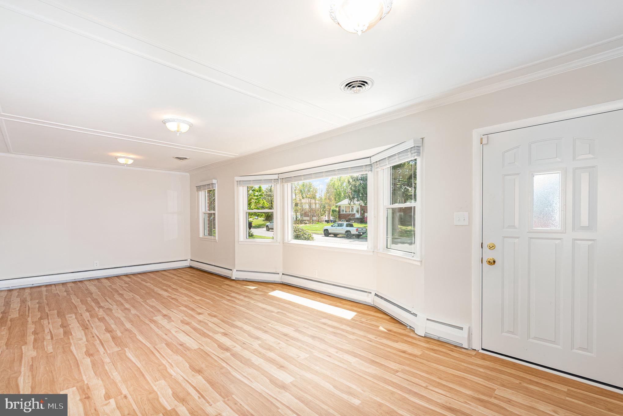 939 Starbit Road Towson, MD 21286 - Photo 19 of 52 an empty room with wooden floor and windows