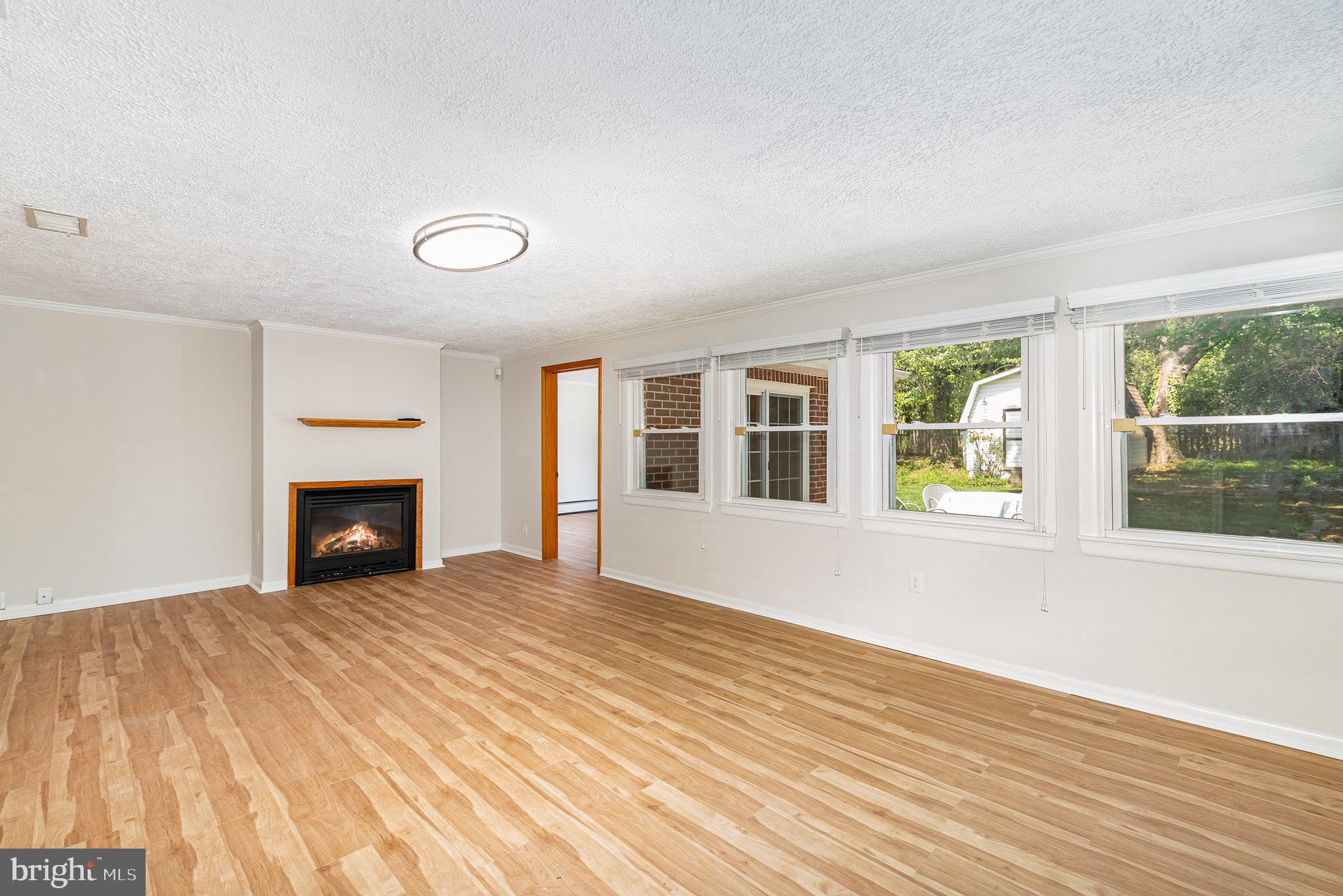 939 Starbit Road Towson, MD 21286 - Photo 20 of 52 a view of an empty room with wooden floor and a window