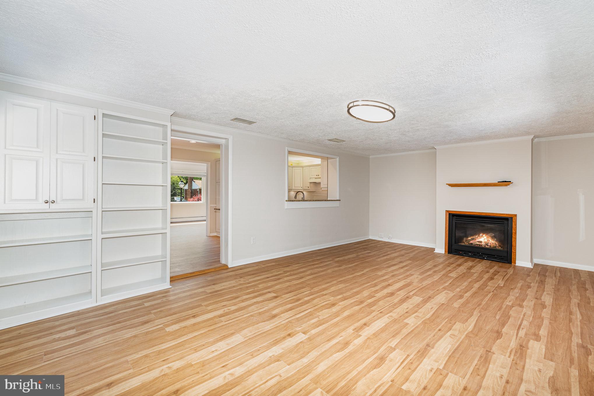939 Starbit Road Towson, MD 21286 - Photo 21 of 52 a view of empty room with wooden floor and fireplace