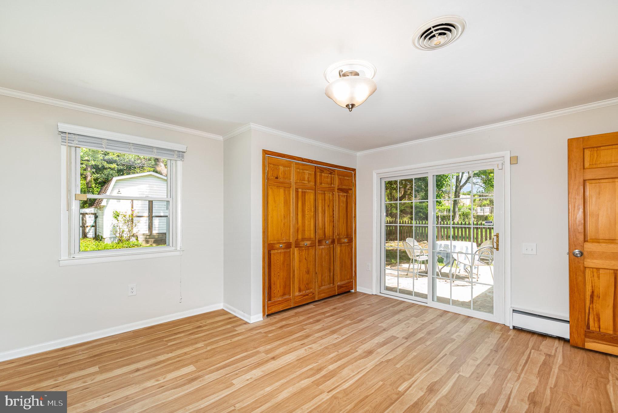 939 Starbit Road Towson, MD 21286 - Photo 24 of 52 a view of an empty room with wooden floor and a window