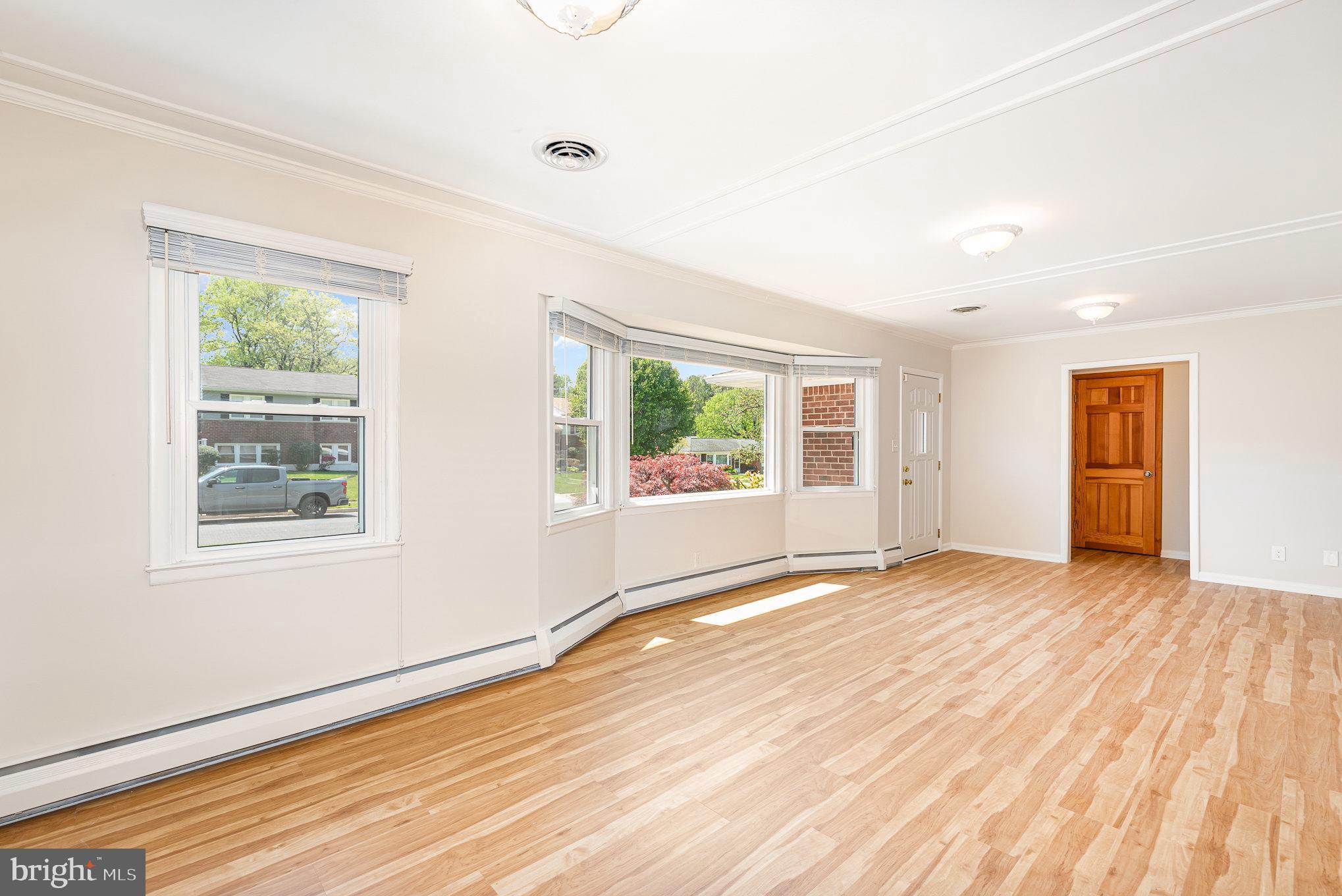 939 Starbit Road Towson, MD 21286 - Photo 25 of 52 a view of an empty room with wooden floor and a window