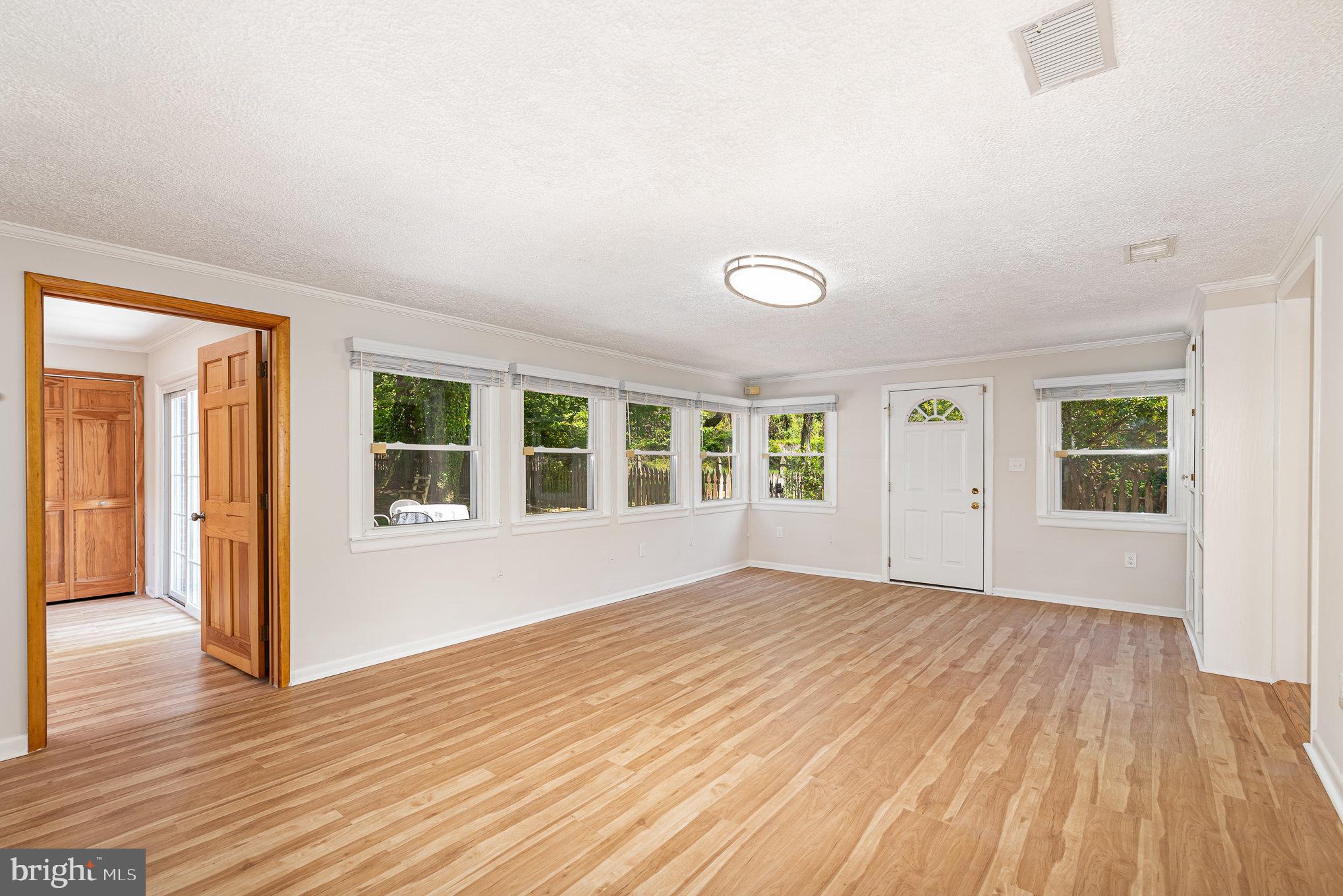 939 Starbit Road Towson, MD 21286 - Photo 26 of 52 a view of an empty room with wooden floor and a window