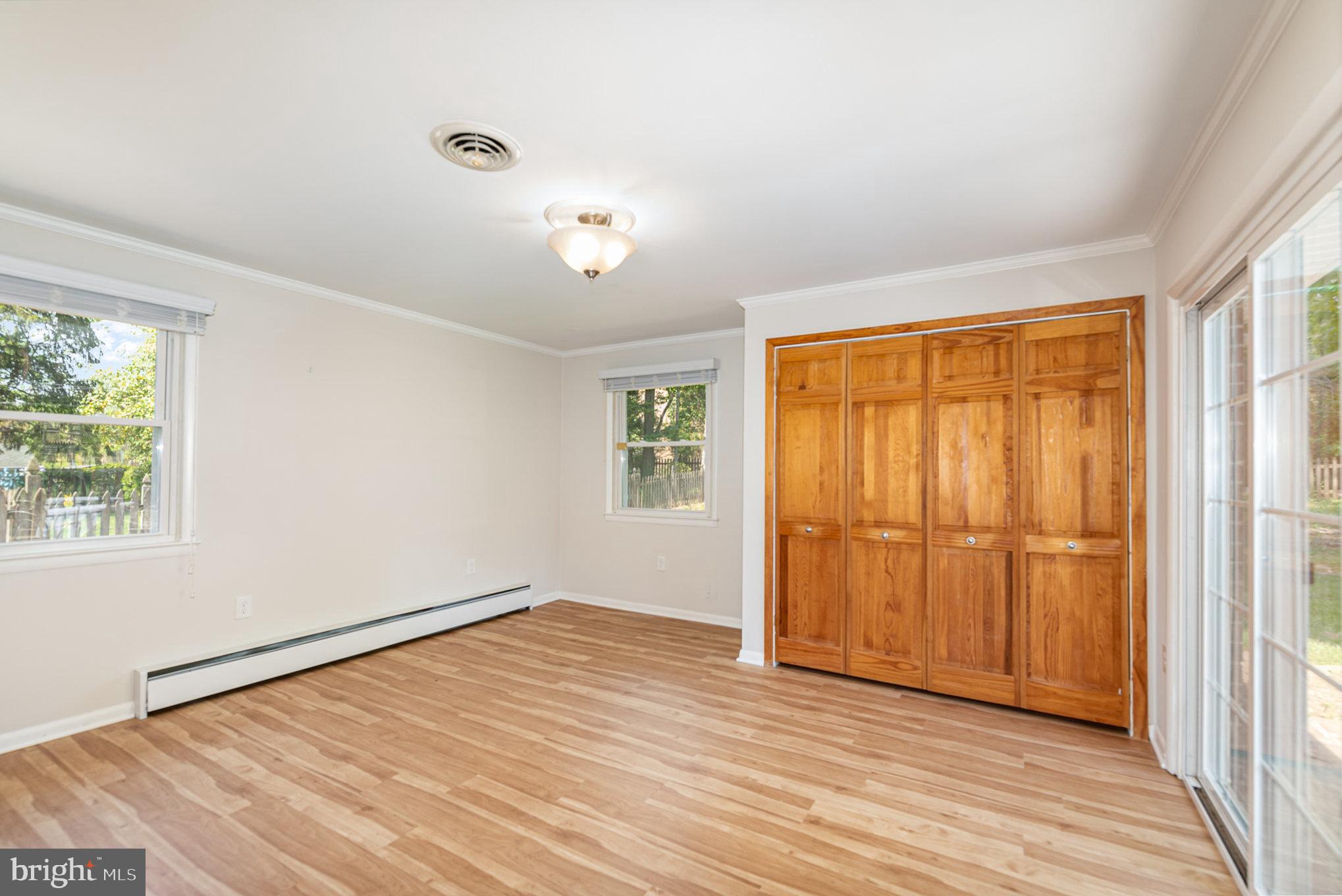 939 Starbit Road Towson, MD 21286 - Photo 27 of 52 an empty room with wooden floor and windows