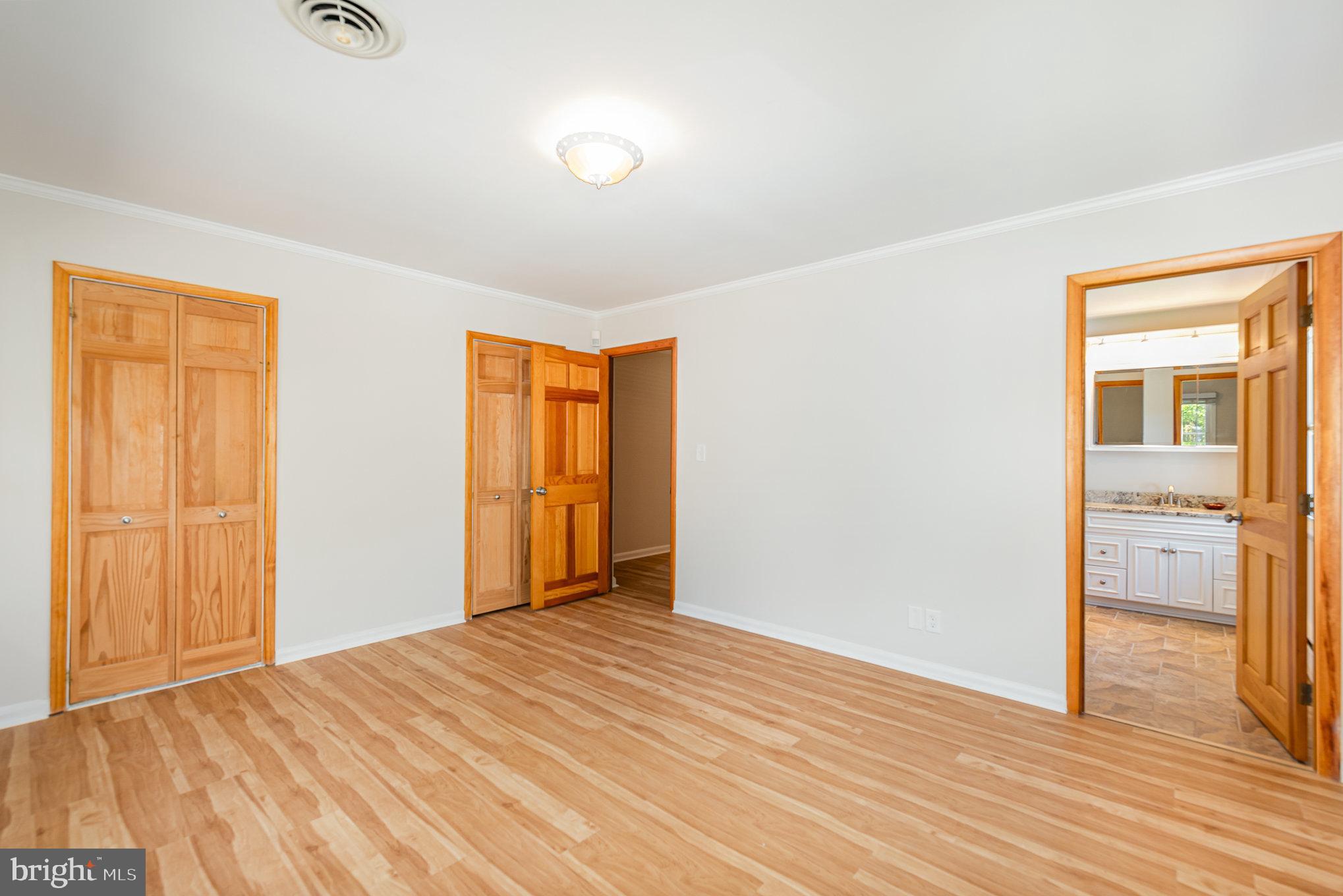 939 Starbit Road Towson, MD 21286 - Photo 29 of 52 a view of an empty room with wooden floor
