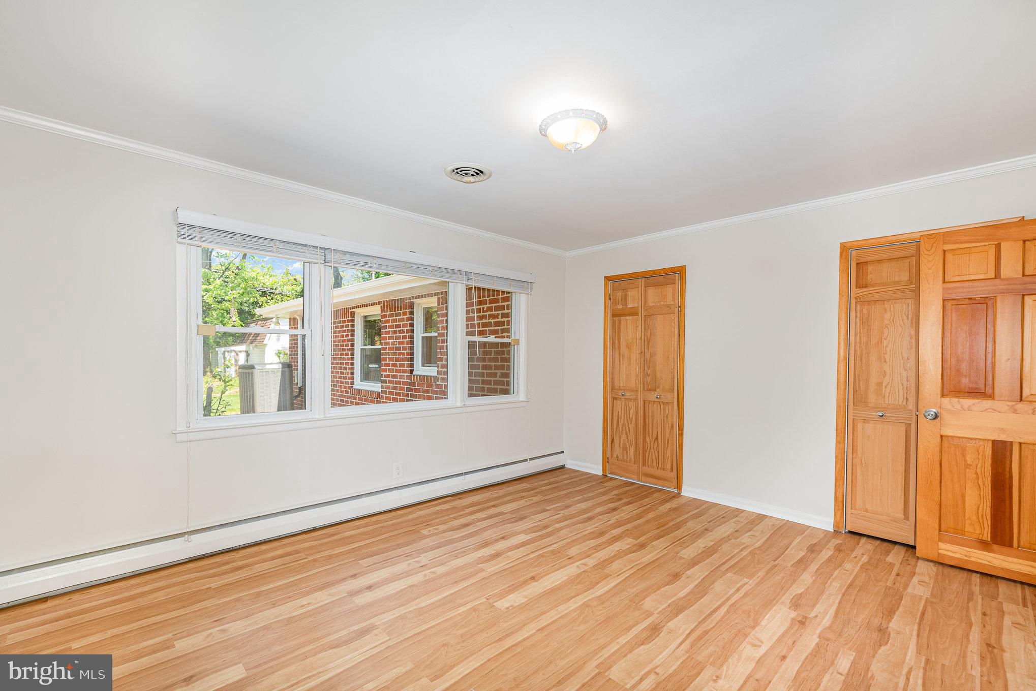 939 Starbit Road Towson, MD 21286 - Photo 30 of 52 an empty room with wooden floor and windows